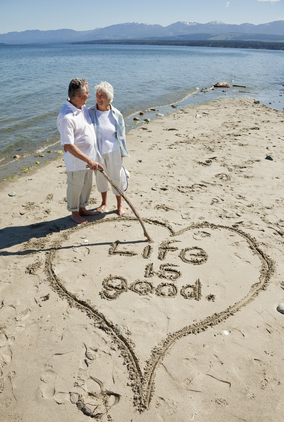 Older couple in a healthy relationship enjoying their vacation on the beach.