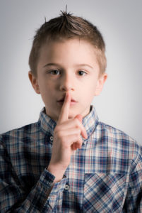 Childhood can teach us that the best way to cope is to be silent, like the boy pictured shh-ing. These habits don't serve us well in most relationships.