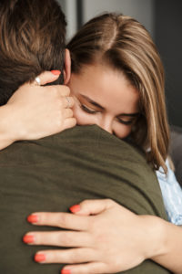 Understanding, forgiveness, and a commitment to doing better can bring you back to hugging like the couple pictured.