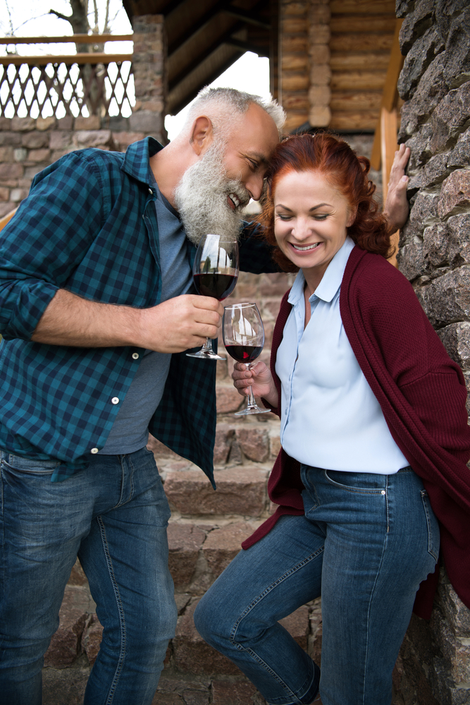 Your partner ultimately wants you to be happy. This happy, senior couple sharing wine illustrates that..
